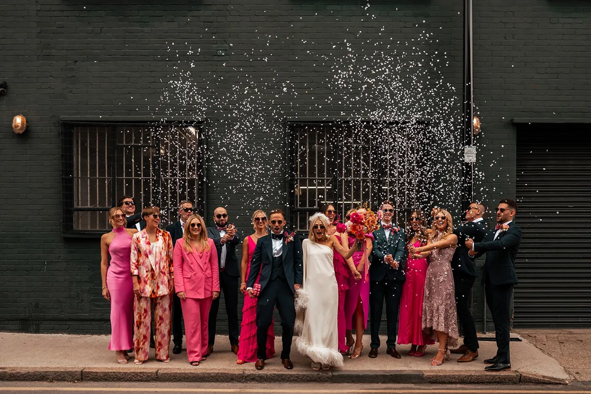 Chloe and Nathan's wedding party throwing confetti outside The Hackney, captured by This Modern Revelry